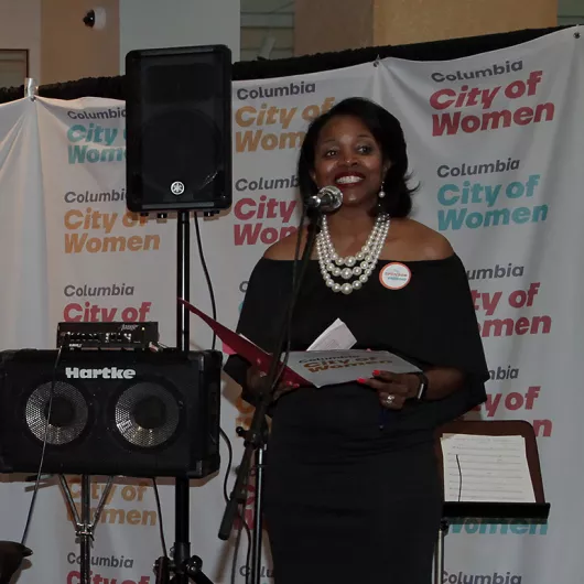 Dr. Traci Cooper presents a Columbia City of Women honoree
